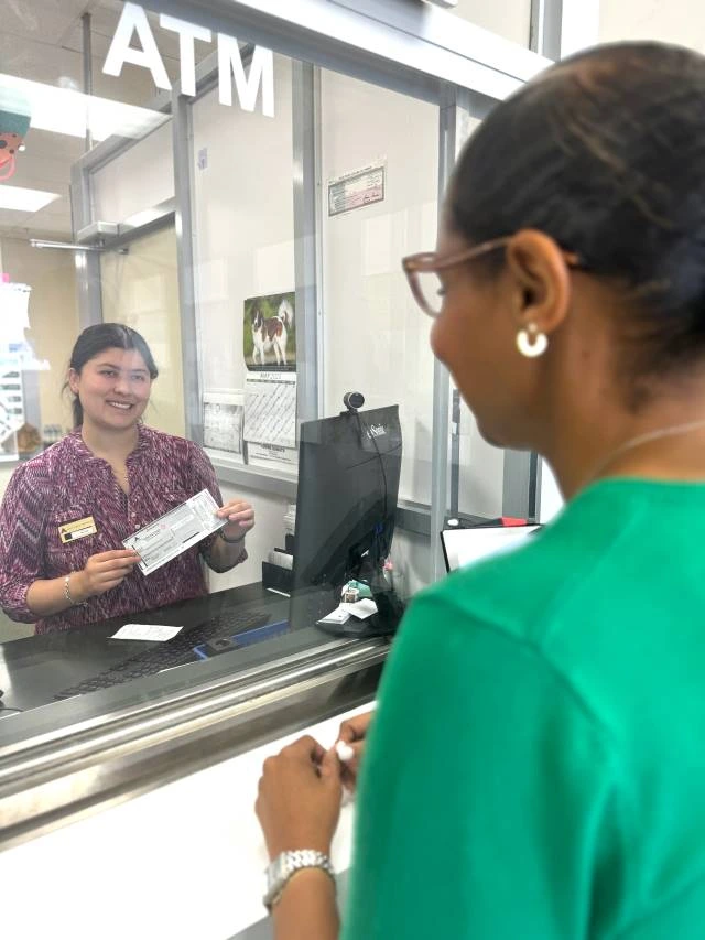 woman purchasing a money order at ACE