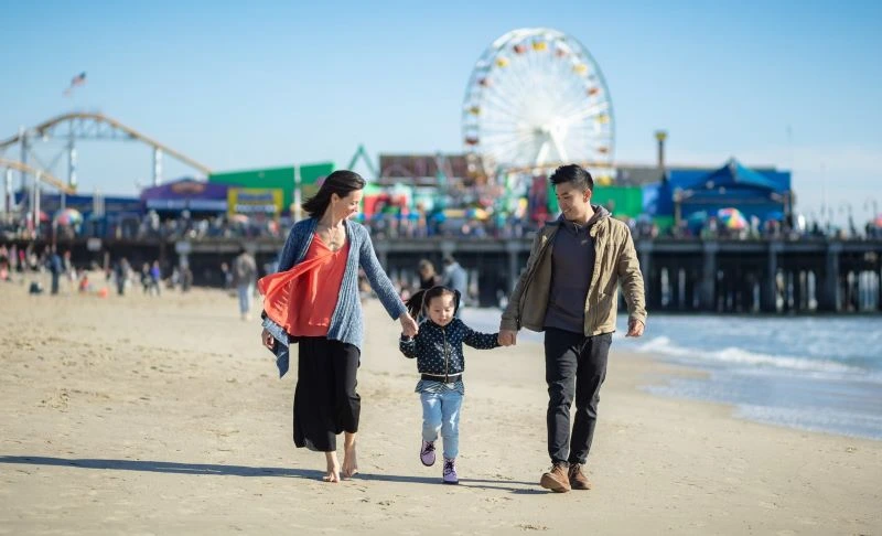 family enjoys a sunny day at the Santa Monica pier