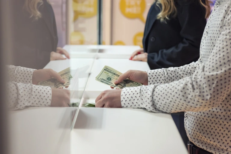 customer paying bills with cash