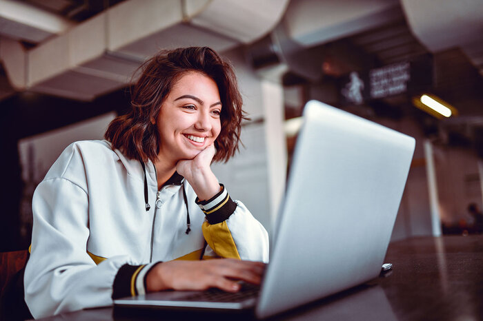 woman looking at paystub on laptop Woman looking at paystub on laptop